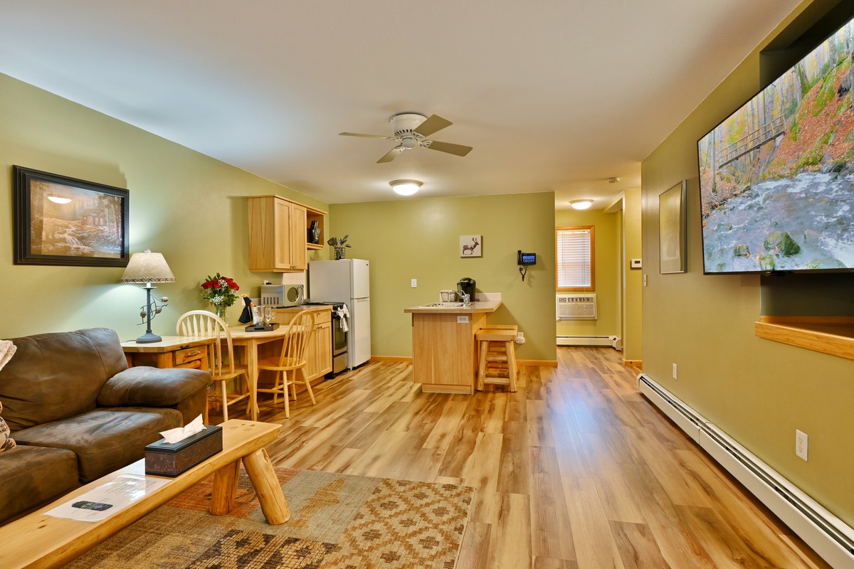 Beautiful Riverview Suite living room with sofa, dining table, and river view